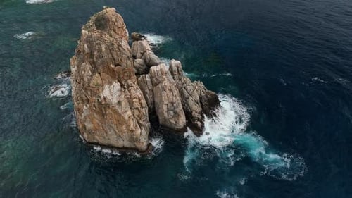 Dramatic Color of the Sea Waves Crashing Against the Rocks Aerial View on a Wild Beach