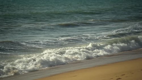 Blue Sea Waves Wash the Sandy Shore