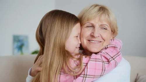 Granddaughter Hugging Grandmother with Love and Joy