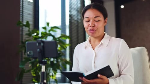 Woman Leading Video Call in Modern Office