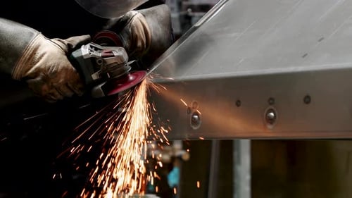 Factory Worker Creating Sparks While Welding