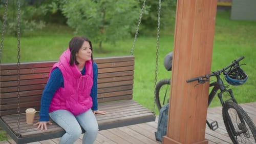 Woman on Park Bench Solitary Woman in Vibrant Attire Enjoys Peaceful Outdoor Moment Casual Woman in