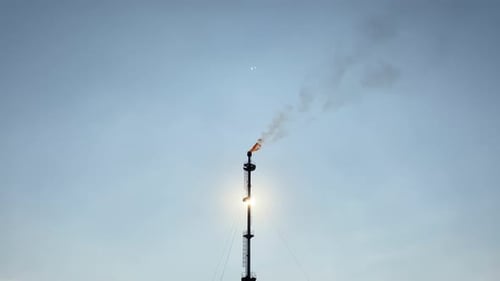 Tall Industrial Chimney Emitting Smoke into the Sky