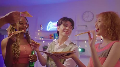 Smiling Friends Enjoy Pizza Party in Living Room