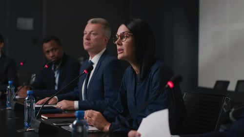 Speech Of Political Speaker At Meeting Room Of Business Center. Adult Woman In Suit Explains Lead...