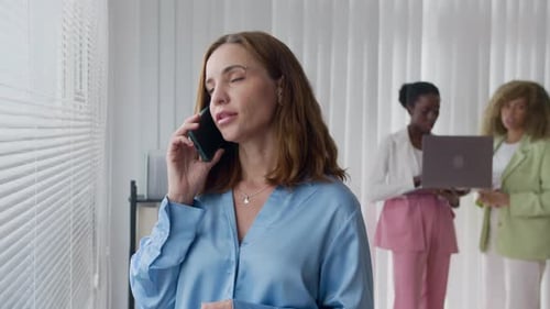 Businesswoman Talking On The Phone In Office