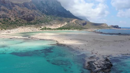 Balos Beach in Crete Greece with blue turquoise-colored water and rocky shore, Aerial flyover shot