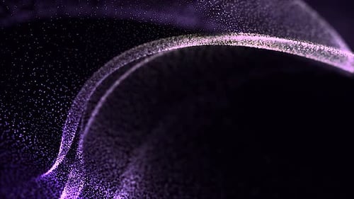 Glowing particles with flare on black background in slow motion.