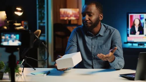 Young Adult Vlogger Presenting a White Box