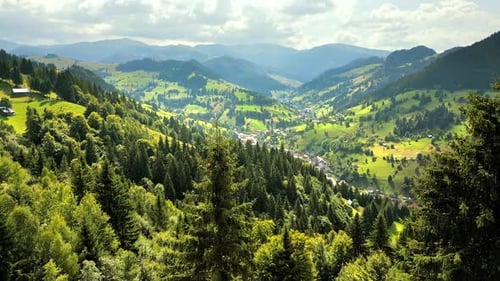 Aerial drone view of Moieciu de Sus, Romania. Small town located in a valley near mountains covered
