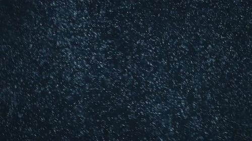 Abstract Particles Falling in Dark Blue Background