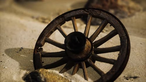 Old Wooden Wheel on Sandy Ground