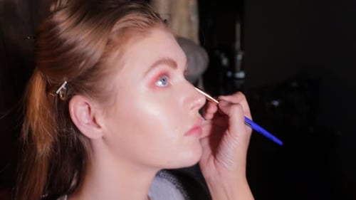 Close-up of model having eye shadow applied by professional make-up artist, smile and laughter - 4K,