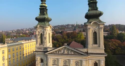 Aerial shot of a Catholic church as approaching, and flying between church bell towers