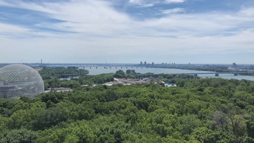 Montreal summer panorama pan shot from the park jean drapeau with the Biosphere and the St Laurent R