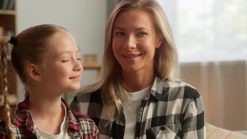 Mother and Daughter Smiling Together in Living Room