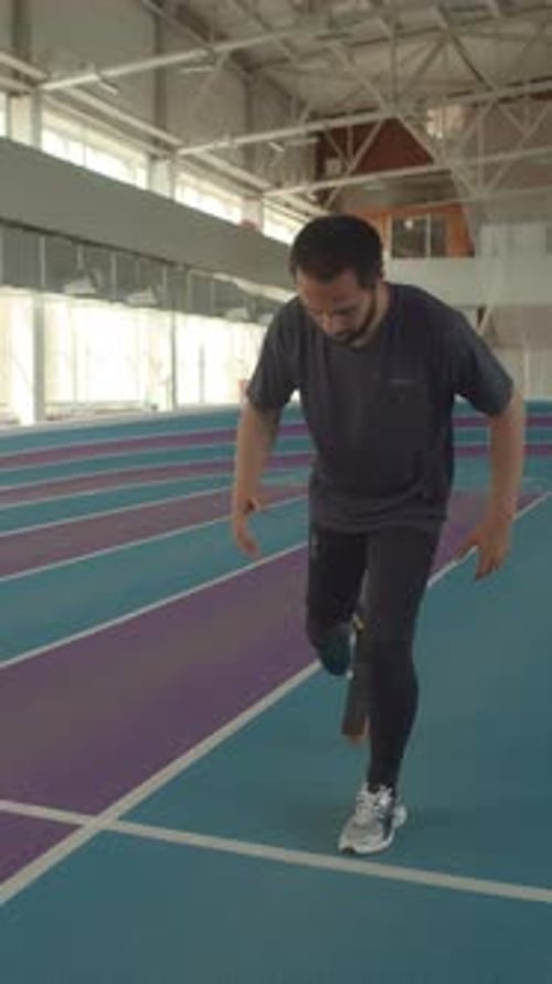 Man with Prosthetic Leg Begins to Jog on Track