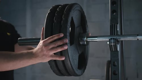 Close Up of Handsome Male Prepare to Do Exercises with Barbell in a Gym