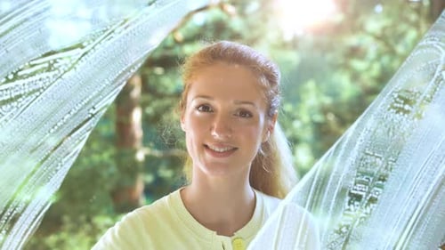 Young Attractive Woman Washes A Window Smiling At The Camera
