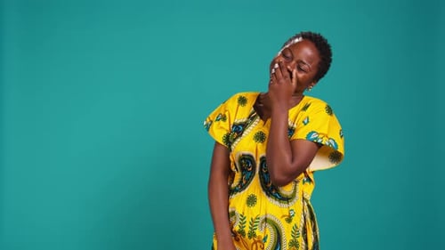 Cute Female Model Giggling Against Blue Background in Studio