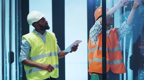 Workers Wearing Safety Gear Collaborating Effectively in a Modern Office Space Environment