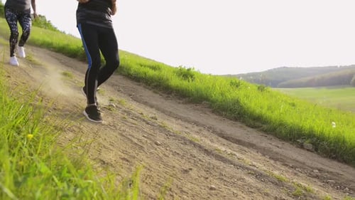 Group of Unrecognizable Seniors Running in Nature on Dirt Road