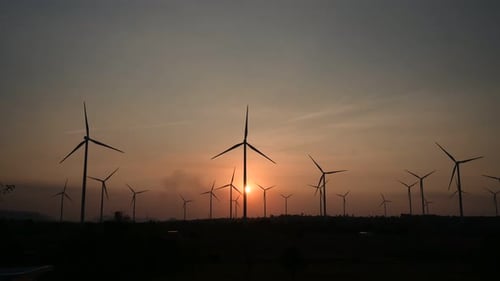 Time lapse of wind turbines are a large source of natural energy that is turned into electrical