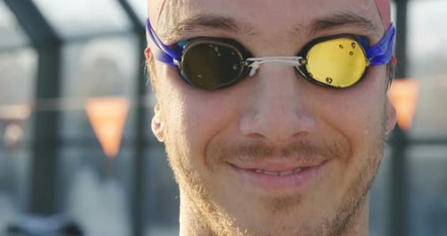 Close Up of Smiling Swimmer in Pool with Goggles