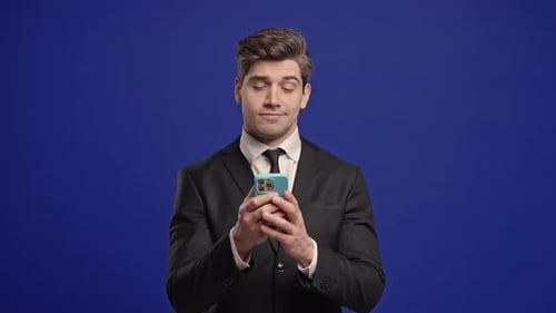 Man in Suit Using Mobile Device