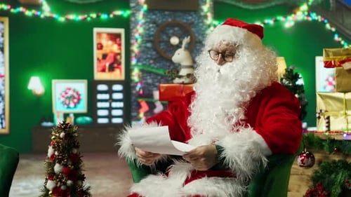Santa Claus Reading Letter in Decorated Christmas Setting