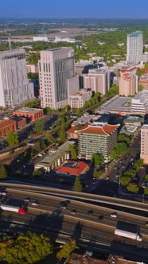 Lively traffic of Sacramento, California, USA. Drone approaching the beautiful downtown