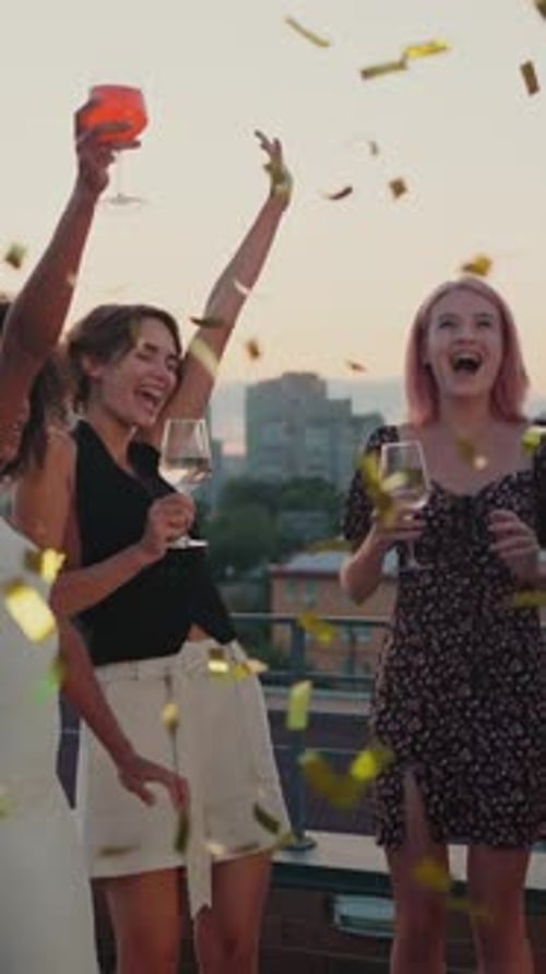 Young and Live Friends Having Cocktail Party with Confetti