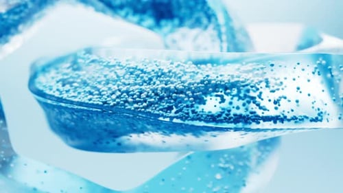 Fließende blaue Partikel in Glasgeometrie