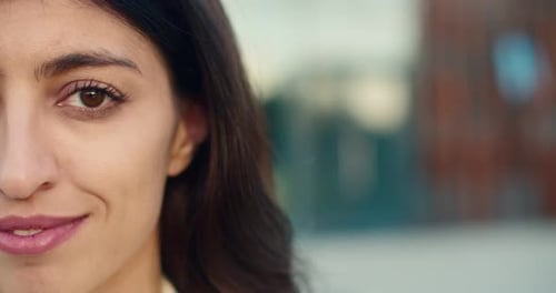 Close Up of Half Face of Young Beautiful Happy Brunette Woman with Long Dark Hair Looking Straight