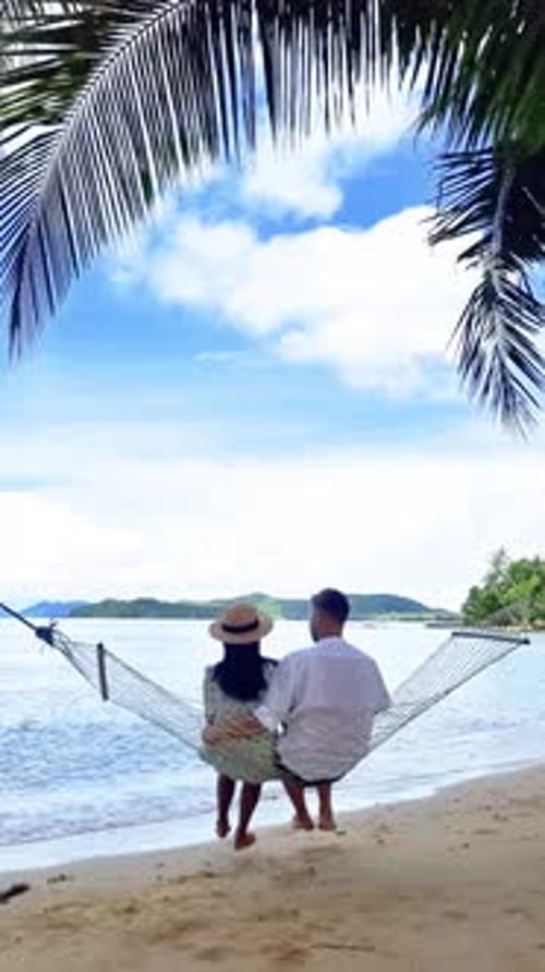 a Man and a Woman are Sitting in a Hammock on the Beach Koh Mak Thailand
