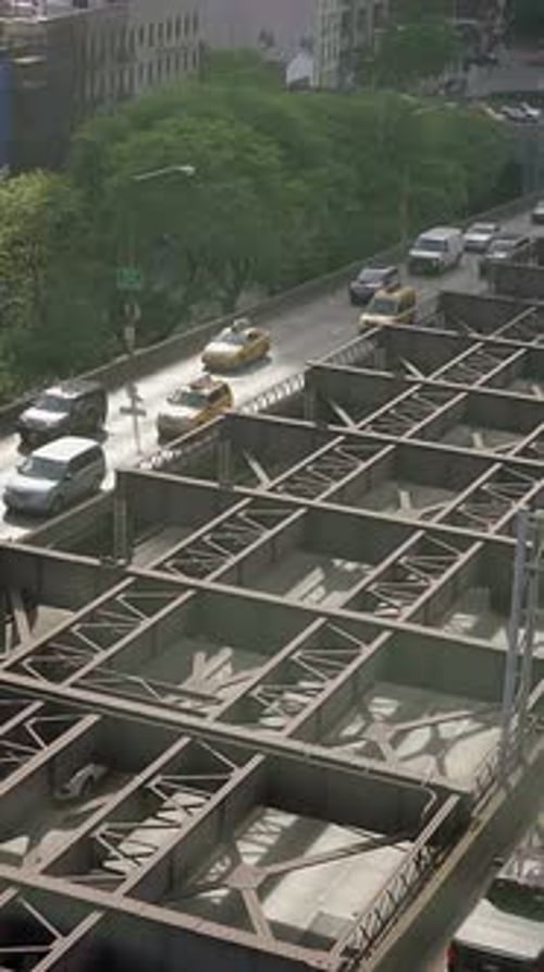 A Bustling Urban Traffic Scene with Vehicles Navigating an Overhead Structure in the City