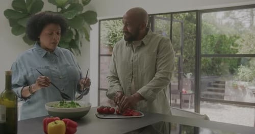 Couple Preparing Salad Together in Kitchen
