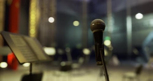 Microphone Stands Ready for Performance in a Modern Concert Hall
