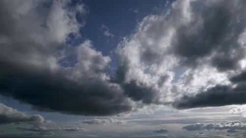 Left to right shot evening sky dark grey clouds covering sun foggy landscape