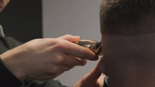 Barber Cutting Hair With Clippers Close Up