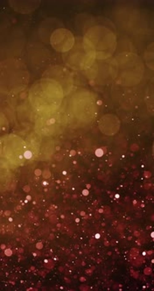 Radiant Yellow Bokeh Amidst Red Particles In Motion