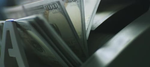 Bills Being Counted in a Currency Counting Machine