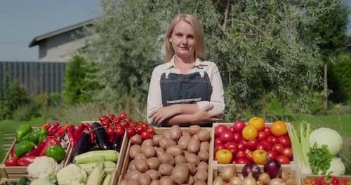 Woman Stands Behind Fresh Vegetable Market Display
