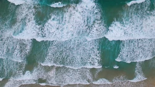 Overhead View of Waves Splash on Desert Beach