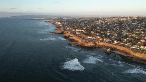 Aerial view of San Diego Cliffs, affluent suburbia and coastline with Pacific Ocean waves, Californi