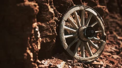 Old Wooden Wagon Wheel in Arid Desert Landscape