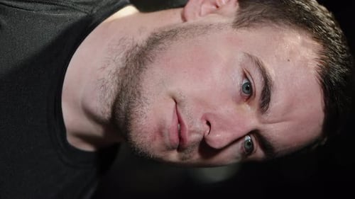 Vertical Screen: Bodybuilder posing in gym after workout