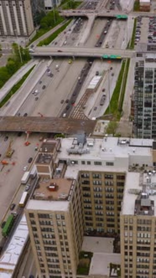 Multiple busy roads with lots of cars on crossing the downtown of contemporary Chicago.
