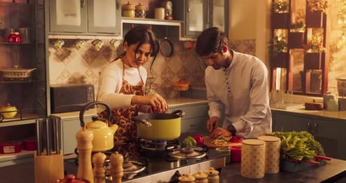 Loving Indian Couple Preparing Food Together in the Kitchen: Young Lovely Couple Enjoy Spending Ti
