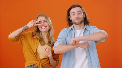 Male and Female Dancing in Place Performing Different Movements